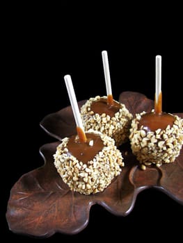 Caramel apples on maple leaf bronze platter.
