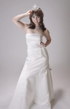 Beautiful young brunette woman as either a prom or beautiy queen