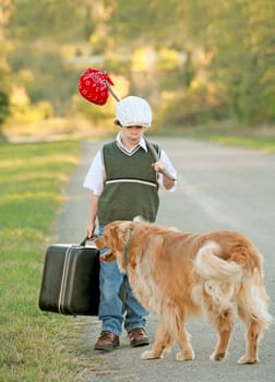 Young Boy Traveling Down the Road with Dog