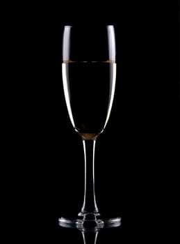 Glass of white wine isolated over black background,