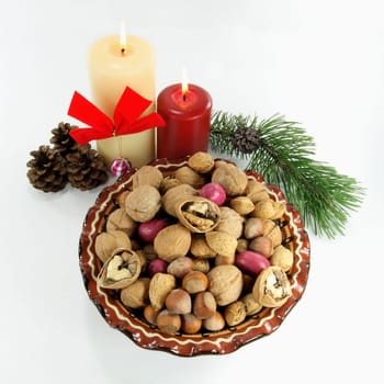 Symbols of Christmas and New Year on White background. Christmas decoration. The good meat of the walnut broken in first minutes of the New year shows good luck during entire year.