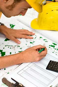 construction worker checking documents and maps