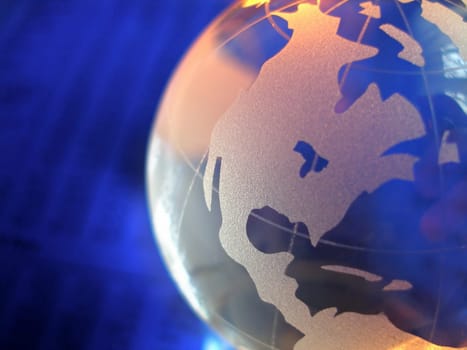 macro of a glass globe in front of business figures, with focus on north and central america