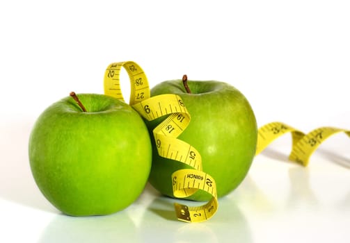 Two green apples and a tape as concept of healthy lifestyle