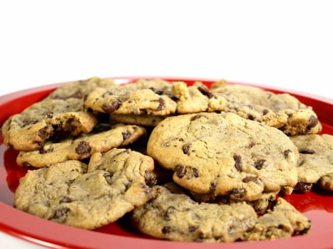 pile of chocolate chip cookies on a red plate