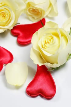 Red hearts and yellow roses on white background