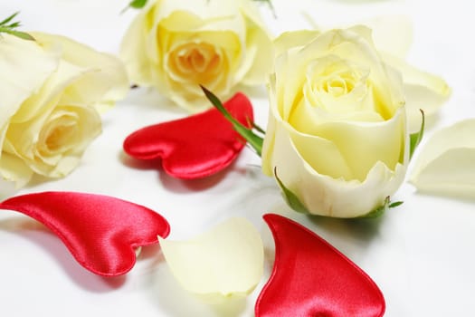 Red hearts and yellow roses on white background