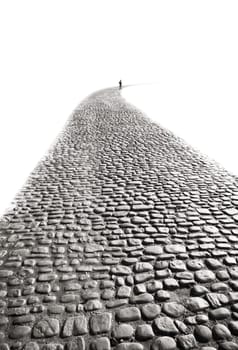 old road, young walker, cobbled, cobblestones, ancient, paving, pavement, curve, perspective, away, going, walking, taking, choosing, figure, distance, concept, choice, progressing, progress, monochrome, contrast, boy, leaving, fading, white, black, rounded, corner, dissapearing