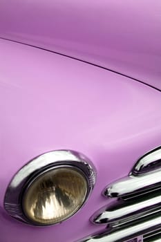 The fender and headlamp of an antique classic car.