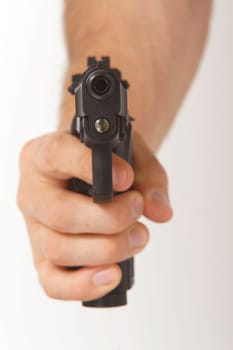A handgun being brandished towards the camera