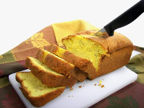 Loaf of poppyseed bread cut into slices.