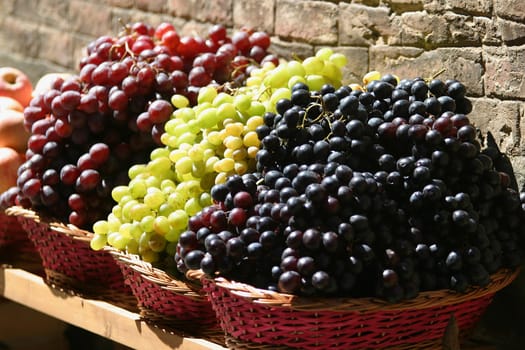 Grapes for sale at a market on the streets of Siena, Tuscany, Italy