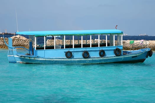 Ship in the Maldives cruising between the reef