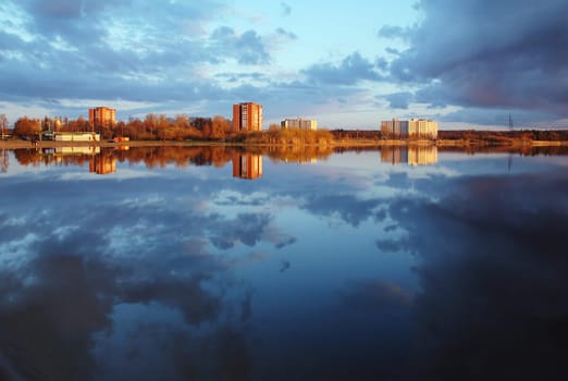 City at the lake, covered on a sunset