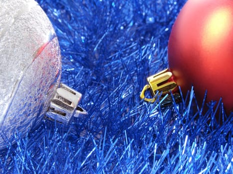 christmas design with colorful baubles and blue tinsel background