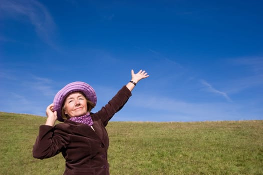 Attractive mature woman enjoying life on the meadow :-)