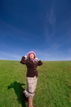 Attractive mature woman enjoying life on the meadow :-)