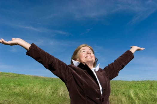 Attractive mature woman enjoying life on the meadow :-)