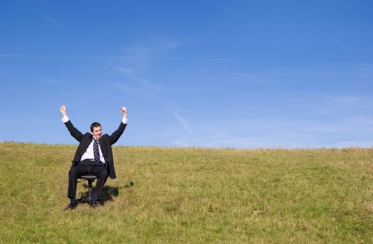 Young businessman on the meadow