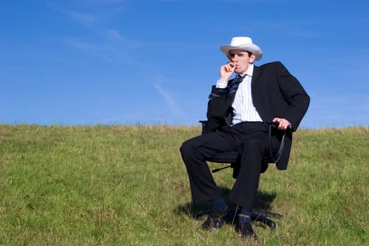 Young businessman on the meadow