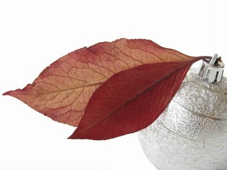 christmas design with bauble and autumnal leaves