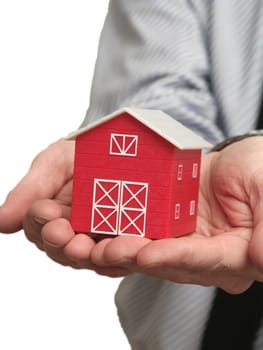 The man holds the red house in a hand