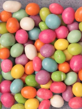 Many multi-coloured sweets lay on a table