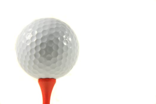 Isolation of a Golf Ball on an Orange Tee on White Background