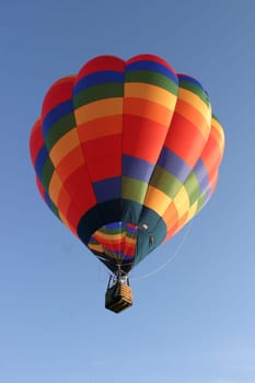 Colorful hot air balloon on blue sky background