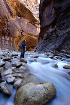 Woman hiking a slot canyon in the Narrows, Zion National Park