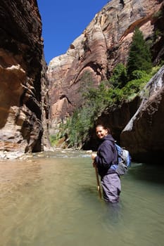 Woman hiking the Narrows in Zion National Park