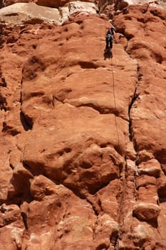 Woman rapelling off a desert tower