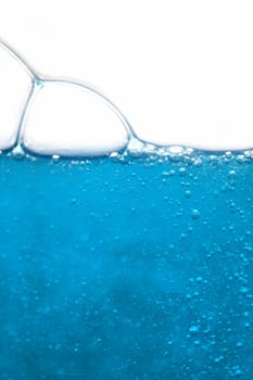 close up of blue liquid with bubbles