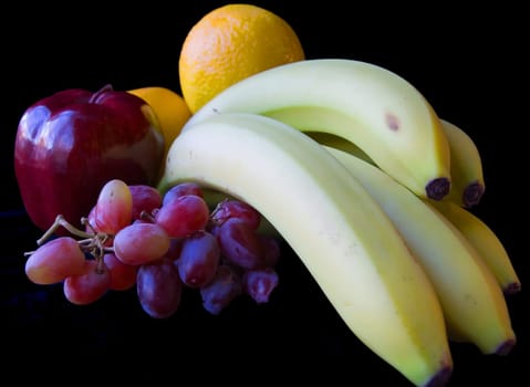 Various fruit on black background