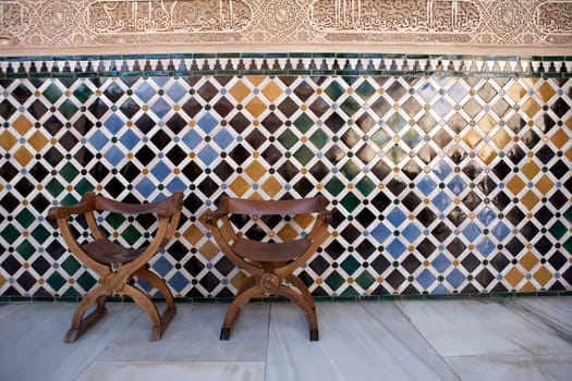 empty chairs in the patio de comares palacios nazaries alhambra palace granada spain andalucia taken in august 2006