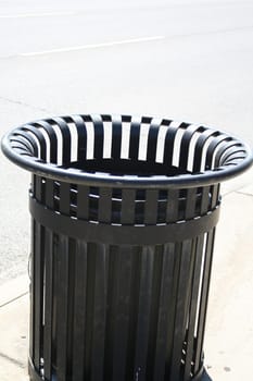 striped garbage can in the street