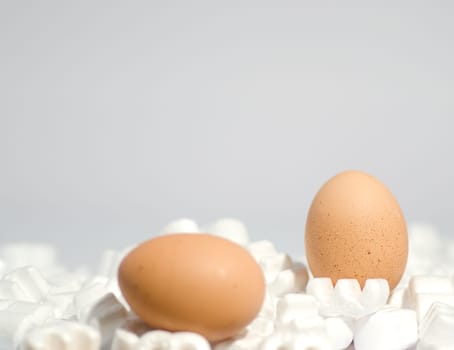 two eggs and packing peanuts symbol of fragility