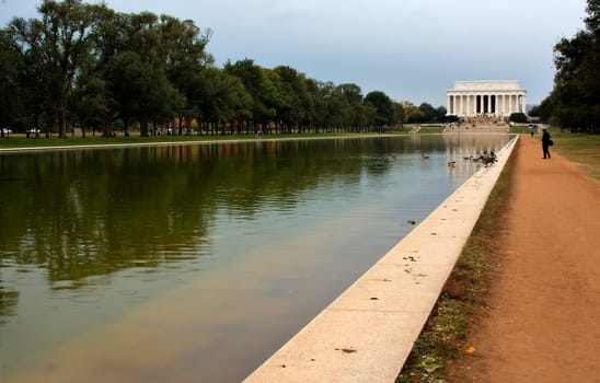 Converging lines of the reflecting pool leading to the Lincoln Memorial in Washington DC