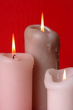 Three lit candles as a background for Christmas or religious theme.