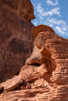 Red Rocky Cliff against Blue Sky