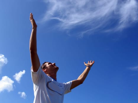 Portrait of a young man with open arms - Success