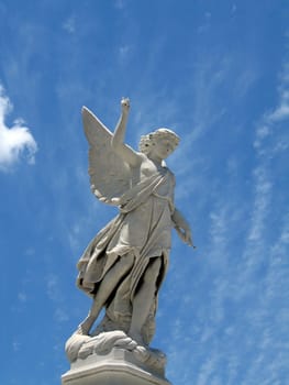 detail of winged angel statue against blue sky