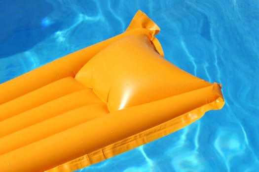yellow airbed floating in bright blue water