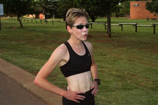 Female marathon champion training in the park.