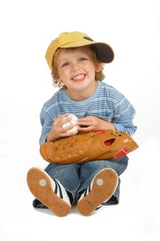 Isolated studio shot with a drop shadow showing a cute little blond boy dressed and ready to play baseball