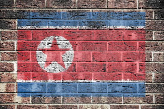 A North Korea flag on old brick wall background