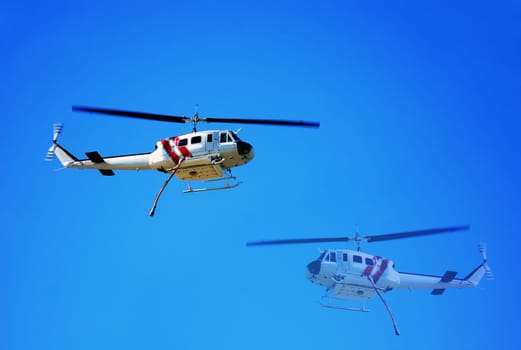 Helicopter making water drops for the firemen on the ground battling California wildfires in Los Angeles.