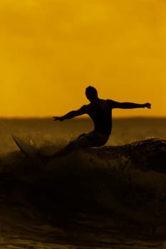 man surfing at sunset