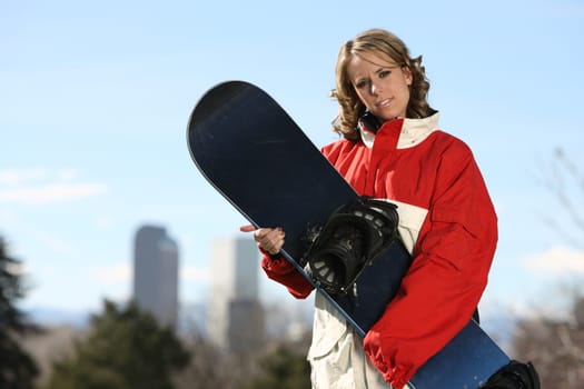 young sexy girl standing with a snowboard