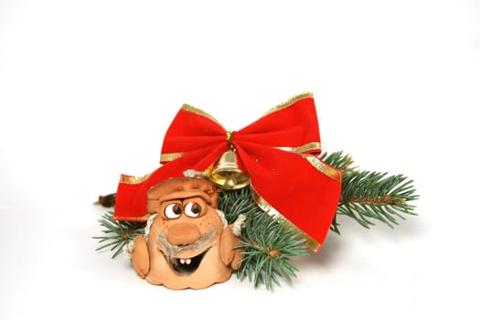 Head-shaped bell with fir-tree branch and red bow as Christmas decoration